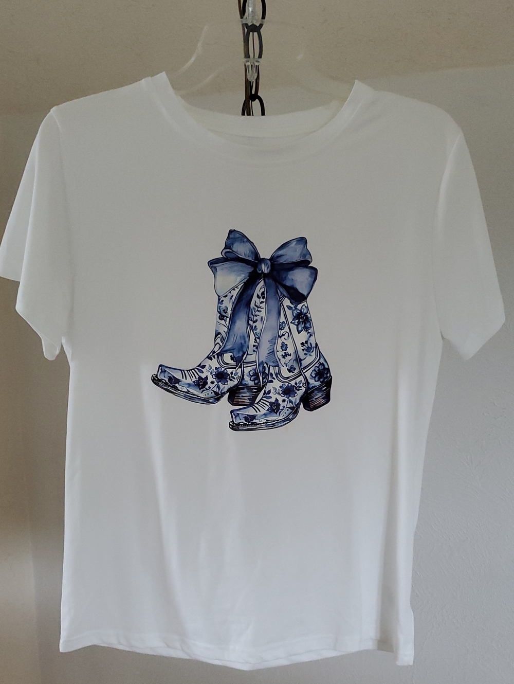 White Women's Graphic Tee with Blue Cowboy Boot Design
